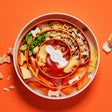Slowfeeder Spin Spiral orange fyldt med foder